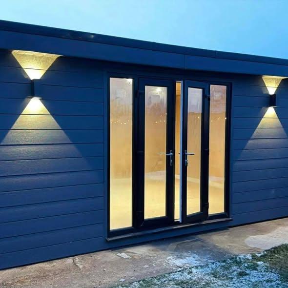 garden room with glass doors and outdoor wall lights